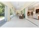 Enclosed patio featuring neutral decor, tile flooring, and sliding doors leading to the backyard at 26 Saint Croix Way, Englewood, FL 34223