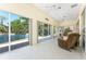 Enclosed patio with views of pond and sliding glass doors leading outside at 26 Saint Croix Way, Englewood, FL 34223