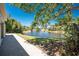 Scenic pond view with lush greenery and mature trees, offering a peaceful and private setting at 26 Saint Croix Way, Englewood, FL 34223