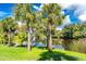 Picturesque pond surrounded by lush greenery and palm trees, offering a serene natural view at 26 Saint Croix Way, Englewood, FL 34223