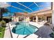 Screened-in pool and spa with patio lounge chairs at 26 Saint Croix Way, Englewood, FL 34223