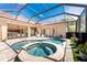 A beautiful screened-in pool and hot tub area with outdoor seating and dining at 26 Saint Croix Way, Englewood, FL 34223