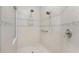 Shower featuring double shower heads, handrails and decorative tile border at 26 Saint Croix Way, Englewood, FL 34223