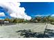 Tennis court with green surface and shelter providing a shaded seating area at 26 Saint Croix Way, Englewood, FL 34223