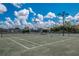 Well-maintained tennis court featuring a covered seating area, enhancing the recreational experience at 26 Saint Croix Way, Englewood, FL 34223