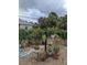 Landscaped backyard with decorative flower pots and lush greenery, creating a serene outdoor space at 2650 Colonade Ln, North Port, FL 34286