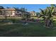 Expansive backyard with lush lawn and garden beds, providing ample space for outdoor activities at 2650 Colonade Ln, North Port, FL 34286