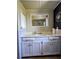 Bright bathroom with a large mirror, ample counter space, and storage cabinets beneath the sink at 2650 Colonade Ln, North Port, FL 34286
