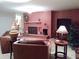 The living room features a cozy brick fireplace and comfortable seating, perfect for relaxing and entertaining guests at 2650 Colonade Ln, North Port, FL 34286