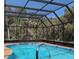Relaxing screened-in pool area with clear blue water and ample room to swim at 2650 Colonade Ln, North Port, FL 34286