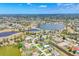 Stunning aerial view of the community featuring multiple lakes, lush greenery, and homes at 27 Sportsman Cir, Rotonda West, FL 33947