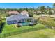 Aerial view of property showcasing fenced backyard, pool, landscaping, and waterfront at 27 Sportsman Cir, Rotonda West, FL 33947