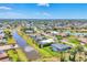 Aerial view of community featuring waterfront homes with lush lawns and landscaping at 27 Sportsman Cir, Rotonda West, FL 33947