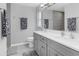 Modern bathroom featuring double vanity, grey cabinets, and tiled walls at 27 Sportsman Cir, Rotonda West, FL 33947