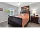 Comfortable bedroom featuring a large bed, ceiling fan, and an abundance of natural light from the window at 27 Sportsman Cir, Rotonda West, FL 33947