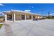 Exterior of building with outdoor seating area and lush landscaping at 27 Sportsman Cir, Rotonda West, FL 33947