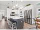 Bright, open kitchen features stainless steel appliances, grey island with seating, and stylish decor at 27 Sportsman Cir, Rotonda West, FL 33947
