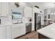 Modern kitchen features stainless steel appliances, white cabinets, and ample counter space at 27 Sportsman Cir, Rotonda West, FL 33947