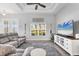 Cozy living room showcasing comfortable seating, entertainment center, and natural light from a nearby window at 27 Sportsman Cir, Rotonda West, FL 33947