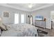 Comfortable main bedroom with tray ceilings, ample natural light, and light grey tones at 27 Sportsman Cir, Rotonda West, FL 33947
