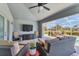 Relaxing patio with comfortable seating, ceiling fan, TV, and a view of the pool at 27 Sportsman Cir, Rotonda West, FL 33947