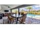 Screened patio featuring a dining area, ceiling fan and a view of the pool and backyard at 27 Sportsman Cir, Rotonda West, FL 33947