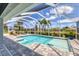 Inviting pool area inside a screened enclosure with ample space and lounge chairs at 27 Sportsman Cir, Rotonda West, FL 33947