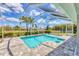Beautiful pool with a screened-in enclosure and well-maintained landscaping at 27 Sportsman Cir, Rotonda West, FL 33947