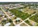 Aerial view of the property showcasing its spacious lot near green spaces and a tranquil pond at 270 E Wentworth St, Englewood, FL 34223