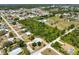 Aerial view of the property showcasing its spacious lot near green spaces and a tranquil pond at 270 E Wentworth St, Englewood, FL 34223