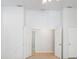 Bright bedroom with high ceilings, neutral paint, and open doorway to another room at 270 E Wentworth St, Englewood, FL 34223