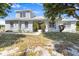 Charming two-story home with a landscaped front yard and inviting front porch, perfect for relaxing outdoors at 270 E Wentworth St, Englewood, FL 34223