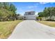 Charming two-story home featuring an attached two-car garage and a long driveway at 270 E Wentworth St, Englewood, FL 34223