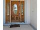 Elegant wood front door with decorative glass panels, adding sophistication to the home's entrance at 270 E Wentworth St, Englewood, FL 34223