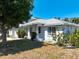 Charming single-story home featuring a well-kept lawn and lovely landscaping at 270 E Wentworth St, Englewood, FL 34223