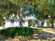 Inviting single-story home with a well-manicured front yard and mature trees at 270 E Wentworth St, Englewood, FL 34223