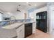 Kitchen with black refrigerator and modern dishwasher at 270 E Wentworth St, Englewood, FL 34223