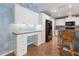 Kitchen with white cabinets, blue countertops, and a breakfast bar with seating at 270 E Wentworth St, Englewood, FL 34223