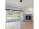 Bright living room with sliding glass doors opening to the pool area and a decorative fireplace at 270 E Wentworth St, Englewood, FL 34223