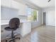 Bright office space featuring built-in cabinets, desk, and wood flooring at 270 E Wentworth St, Englewood, FL 34223
