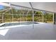 Screened in pool area with ample patio space and lush landscaping creates a perfect oasis at 270 E Wentworth St, Englewood, FL 34223
