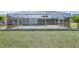 Spacious backyard featuring a screened-in pool and plenty of green space at 3246 Yukon Dr, Port Charlotte, FL 33948