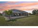 Enclosed patio overlooking the manicured backyard, offering a perfect blend of indoor and outdoor enjoyment at 3246 Yukon Dr, Port Charlotte, FL 33948