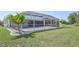 The large backyard includes a screened-in pool and lovely landscaping for outdoor enjoyment at 3246 Yukon Dr, Port Charlotte, FL 33948