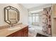 Nicely appointed bathroom featuring decorative mirror, vanity, and tiled shower with tub at 3246 Yukon Dr, Port Charlotte, FL 33948
