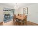Cozy dining room with a chandelier, wood table and chairs, and sliding door access to the outdoors at 3246 Yukon Dr, Port Charlotte, FL 33948