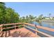 Wooden dock overlooking tranquil waters and lush greenery at 3246 Yukon Dr, Port Charlotte, FL 33948