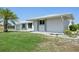 A well-manicured lawn surrounds this lovely home with a modern metal roof and thoughtfully placed landscaping at 3246 Yukon Dr, Port Charlotte, FL 33948