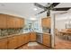 The open kitchen boasts granite counters, wood cabinets, and stainless steel appliances with views to backyard and dining area at 3246 Yukon Dr, Port Charlotte, FL 33948