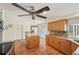 Spacious kitchen featuring granite counters, wood cabinets, stainless fridge, and center island with breakfast bar at 3246 Yukon Dr, Port Charlotte, FL 33948